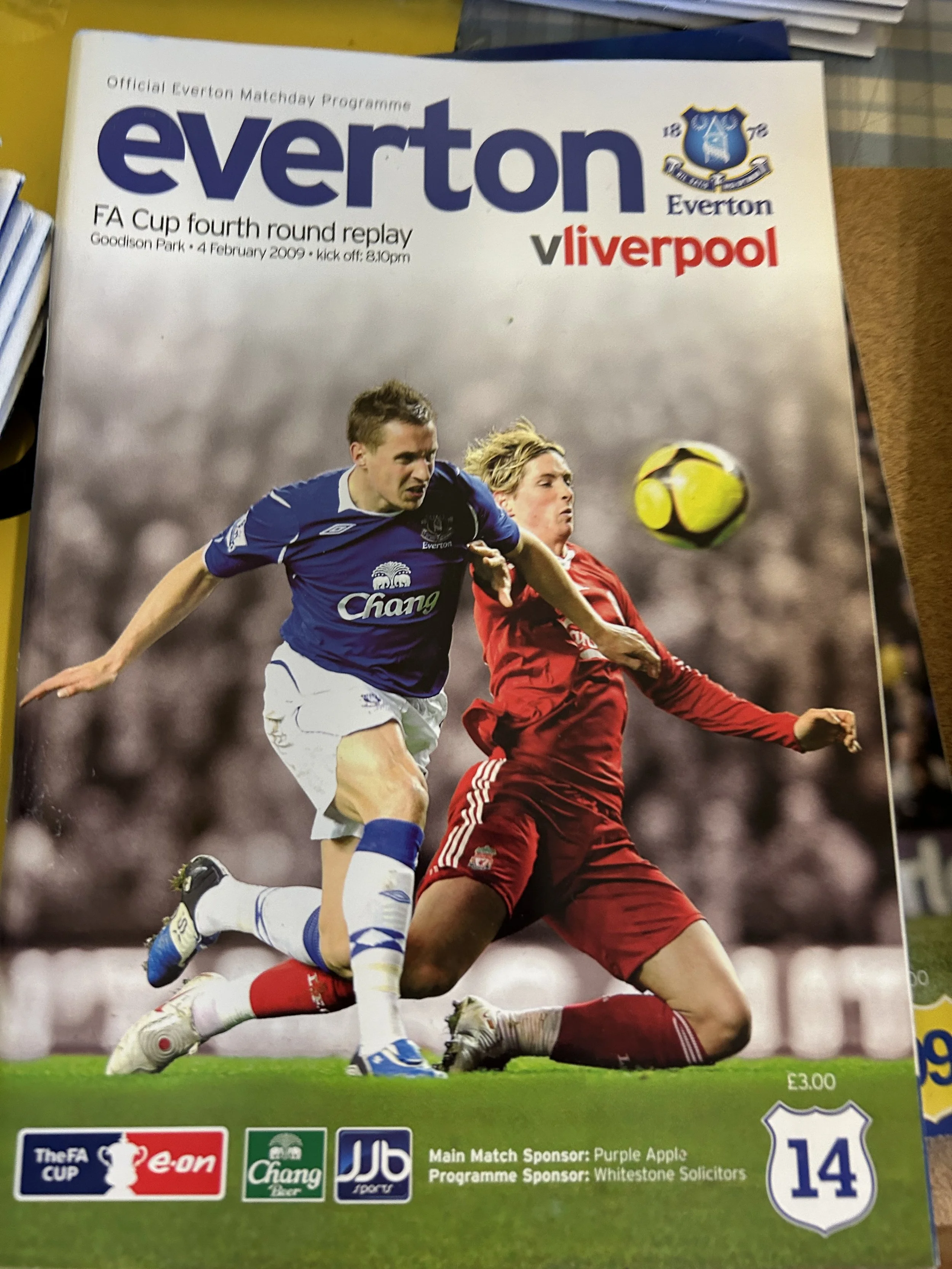 Cover page of Everton football match program for FA Cup fourth round replay against Liverpool, held on February 4, 2009, at Goodison Park, featuring an action shot of two soccer players competing for the ball.