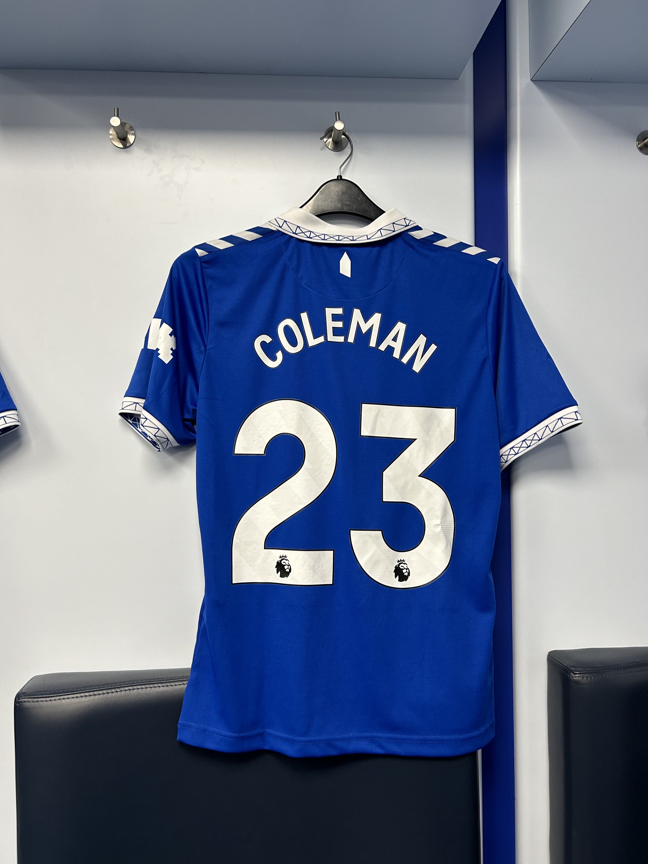 Back of a blue soccer jersey with the name 'COLEMAN' and the number '23', featuring the Premier League logo and design accents on the sleeves and collar.