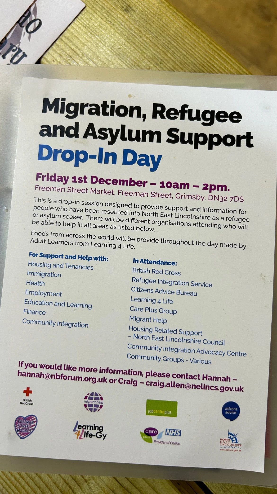Flyer for a drop-in event supporting migration, refugees, and asylum seekers on December 1st at the Freeman Street Market, focusing on various support services and attendance by organizations like British Red Cross and Learning for Life.