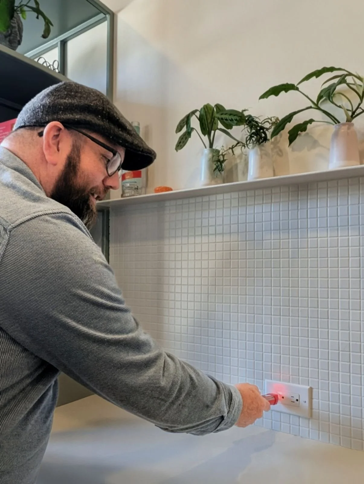 man testing electrical receptacle