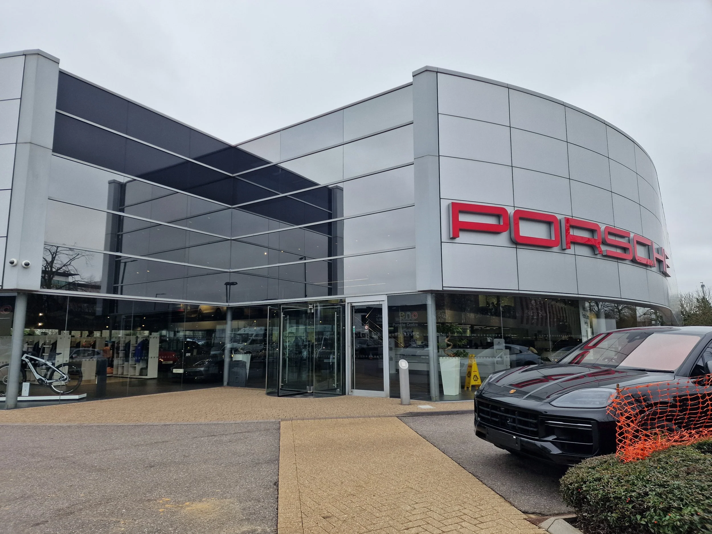 Porsche Dealership in Portsmouth with dark reflective window films to reduce glare and UV rejection. 