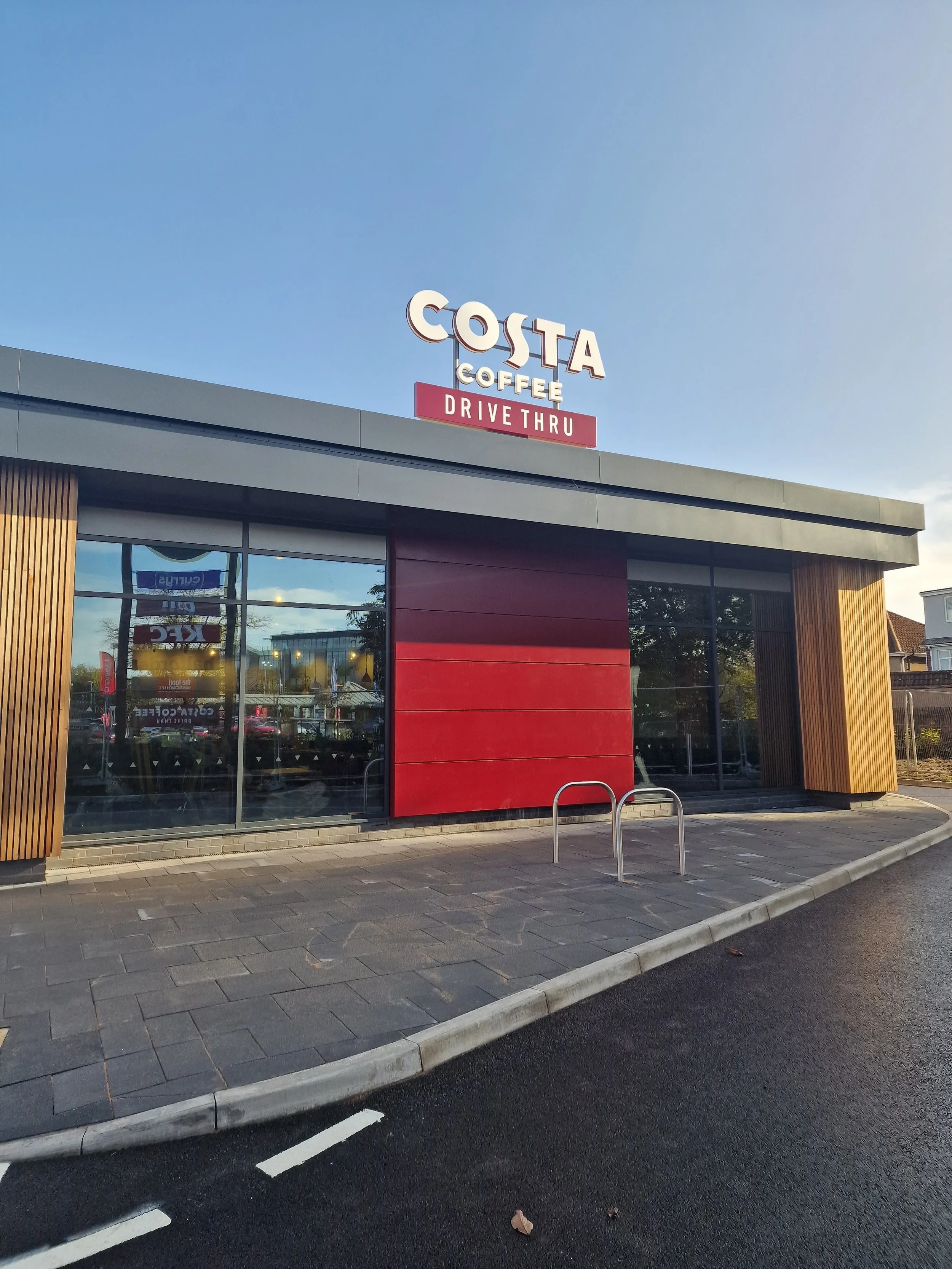 Dark neutral window film to at Costa Cafe to reduce glare.