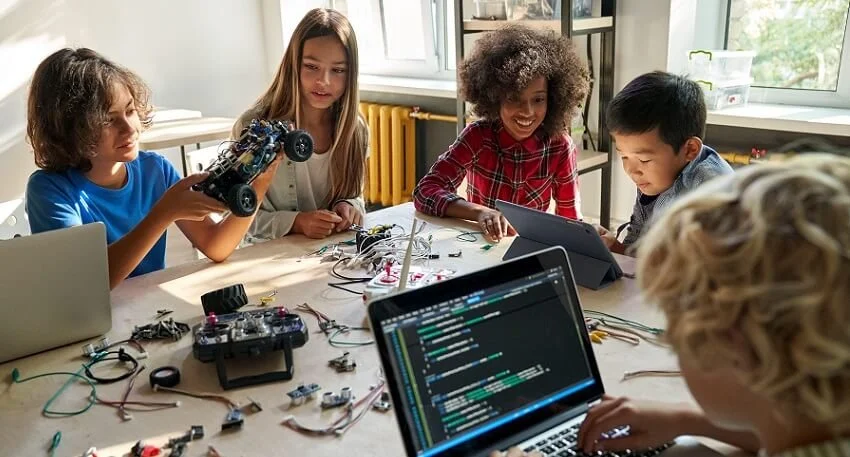 Kids participating in a hands-on robotics and coding program, building robots and learning programming skills