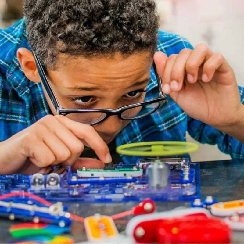 Child participating in a hands-on STEAM program combining engineering, technology, and creative problem-solving