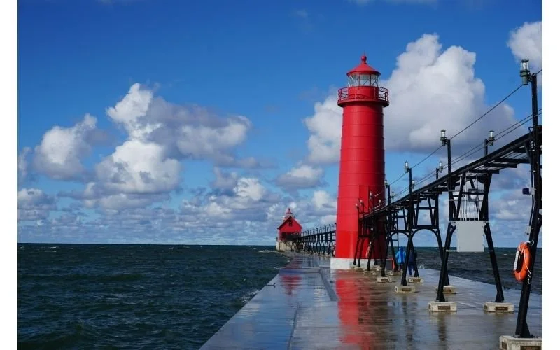 Red lighthouse along the Michigan shoreline on a clear day