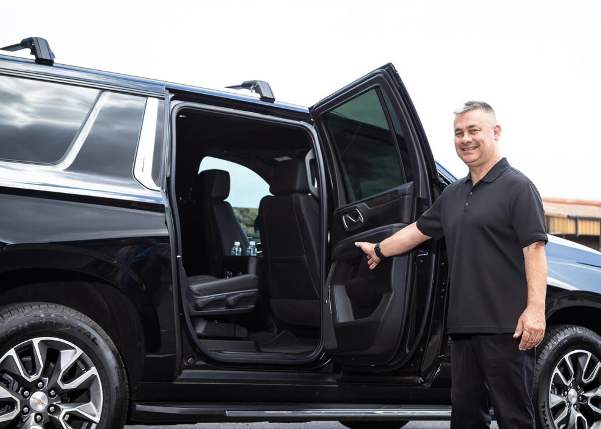 Primo VIP driver welcoming guests into a luxury private SUV on Maui.