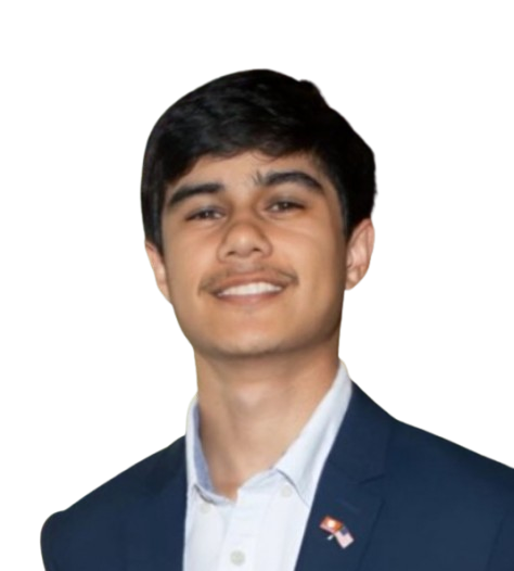 A young man in a navy suit and white shirt smiling, with an American flag pin on his lapel, standing against a black background.