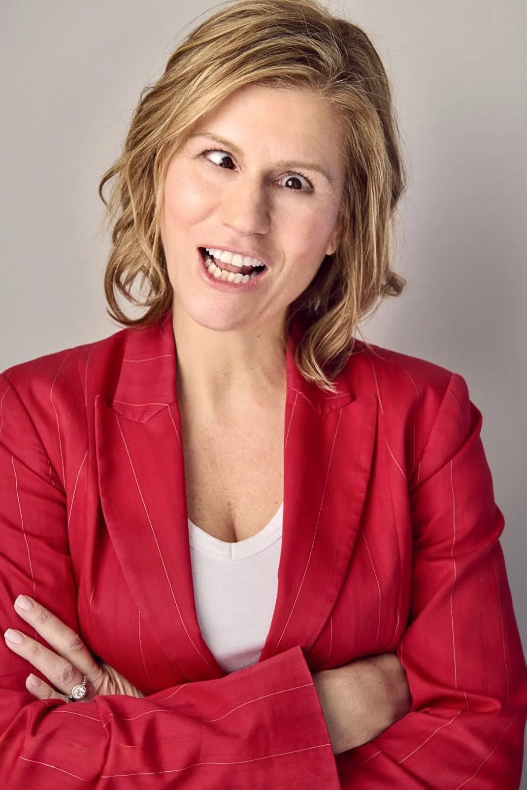 A funny and playful headshot of comedian and actress, Kerri Louise.