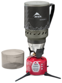 A portable camping stove with a black MSR fuel canister, a red MSR fuel bottle, a beige pot, and a black fuel line.