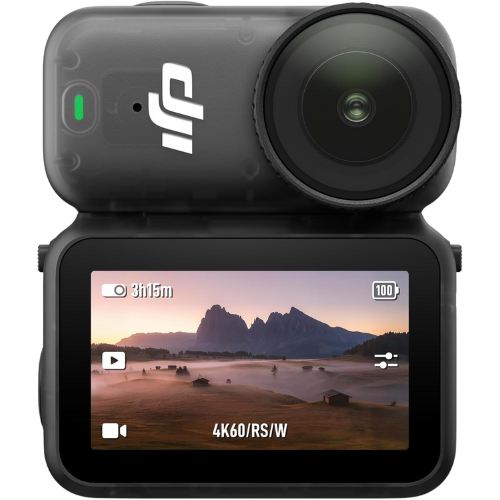 Action camera mounted on a surface, showing a landscape of distant mountains and a misty field on its screen.