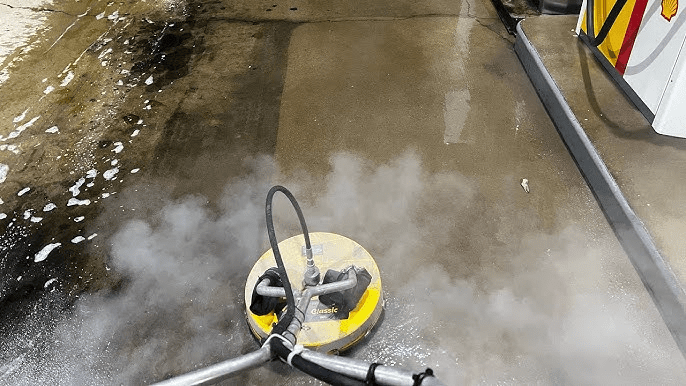 Gas station concrete cleaning in Duluth, MN, removing oil stains and grime from the pump islands and storefront.