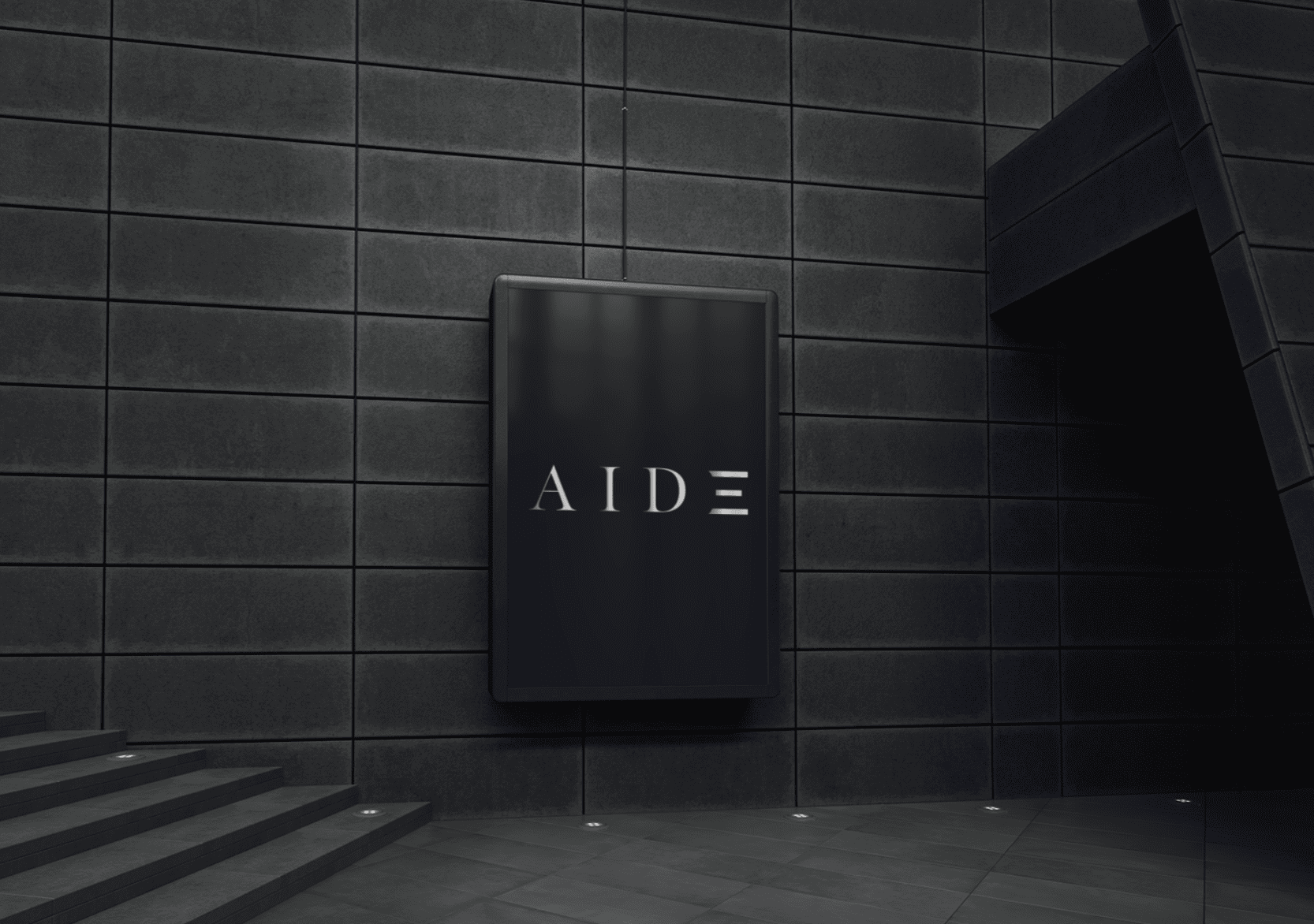 Modern building entrance with black tiled walls, a black illuminated sign with the word 'AIDE' in white, and stairs leading up to the entrance.