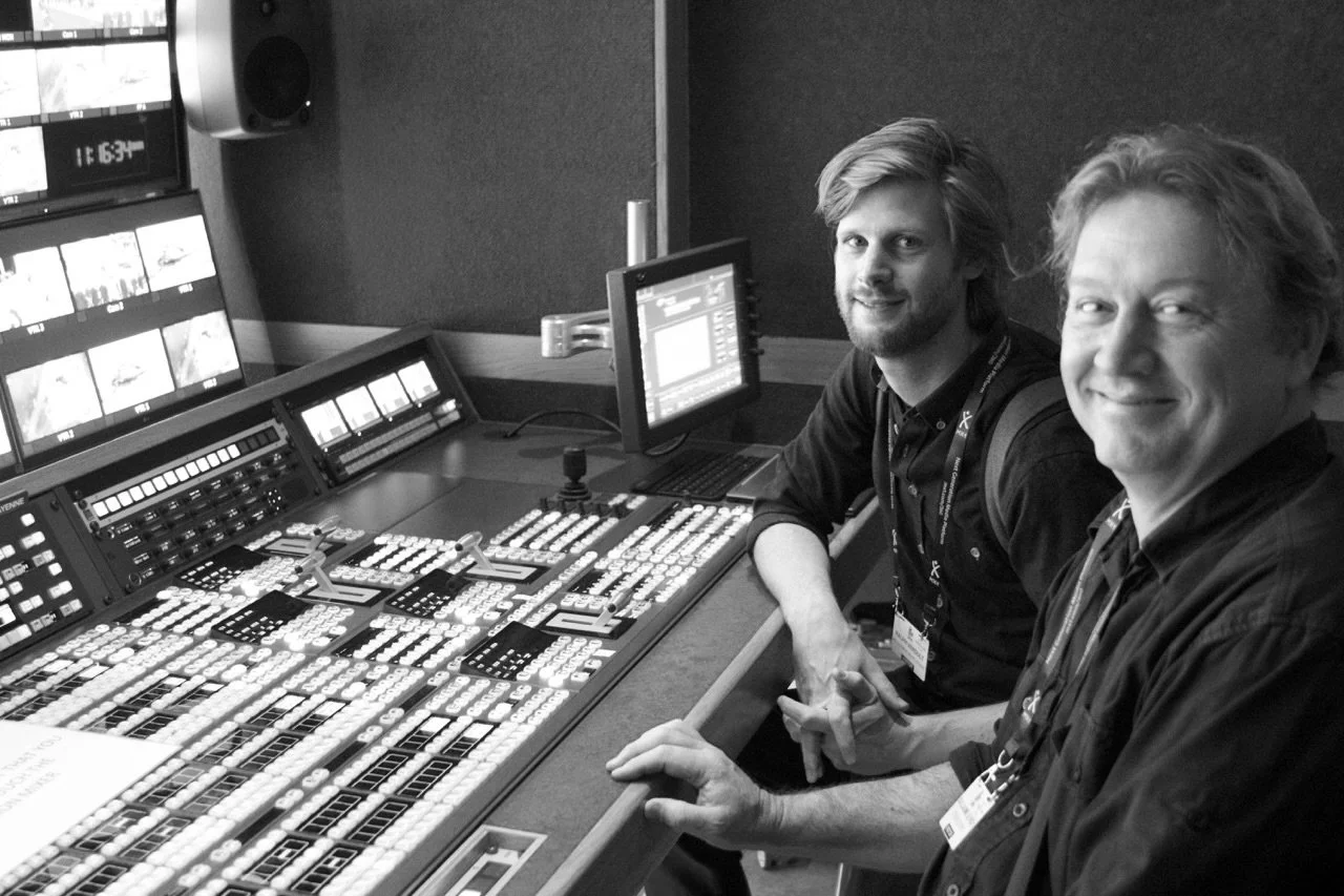 Mikel Le Roy and Ralph Verdult sitting at a console with multiple monitors and control panels.