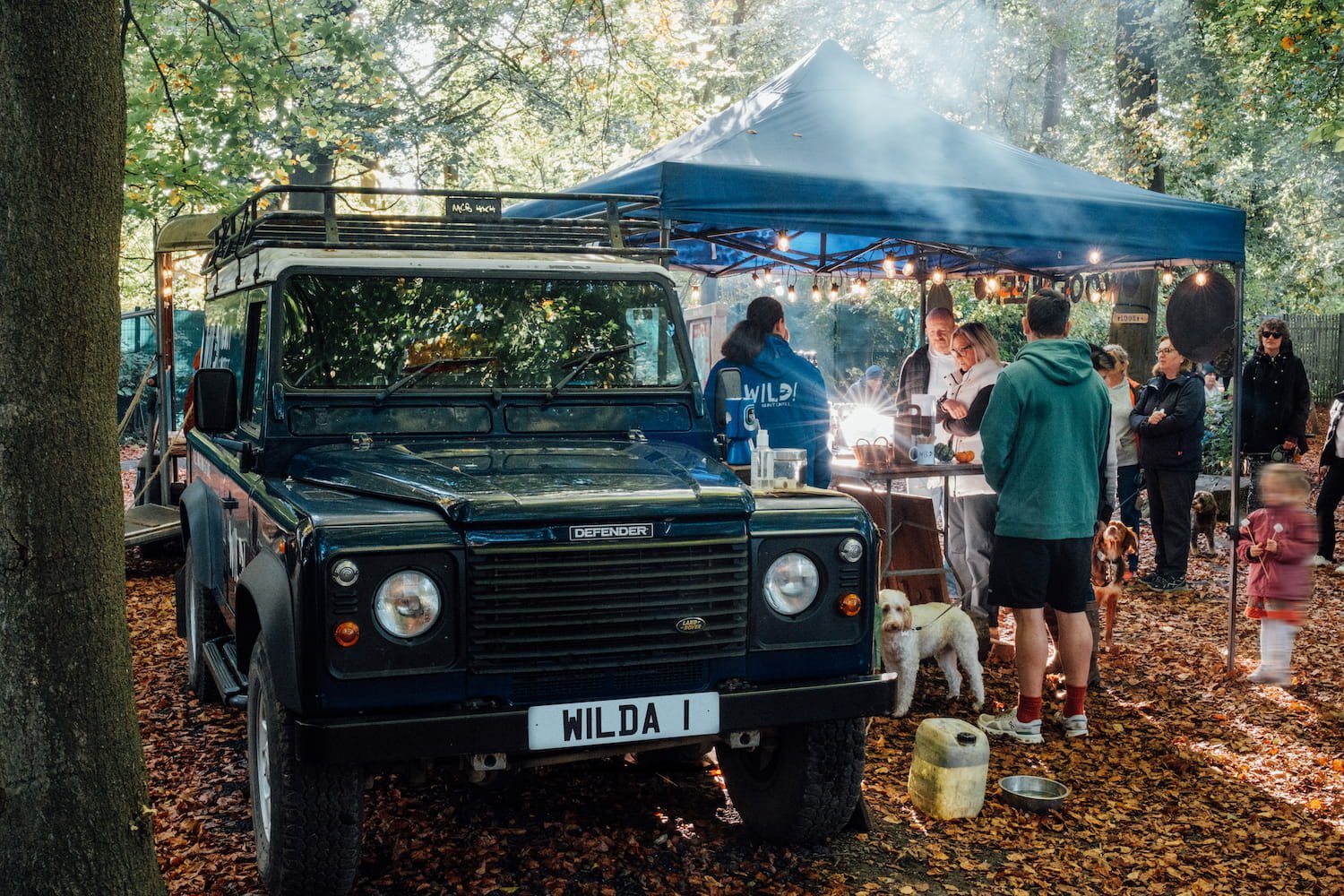  Wild About Coffee Land Rover defender serving barista coffee to families and friends under a canopy in Norbury Park woods. 