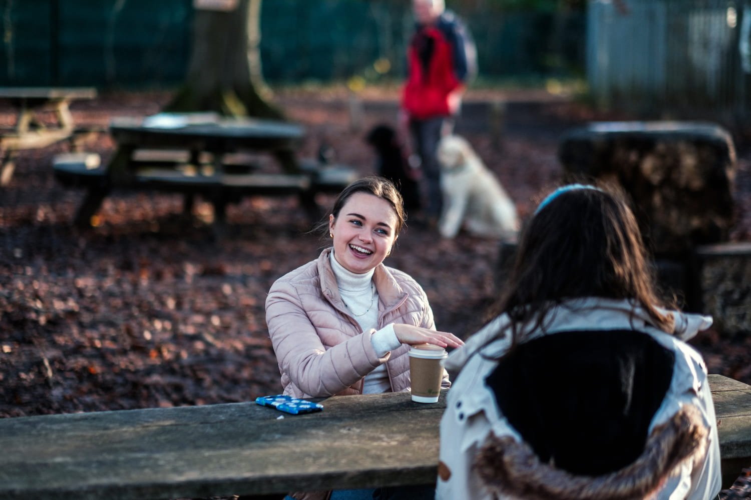  Two people enjoying coffee in Norbury Park Woods. 