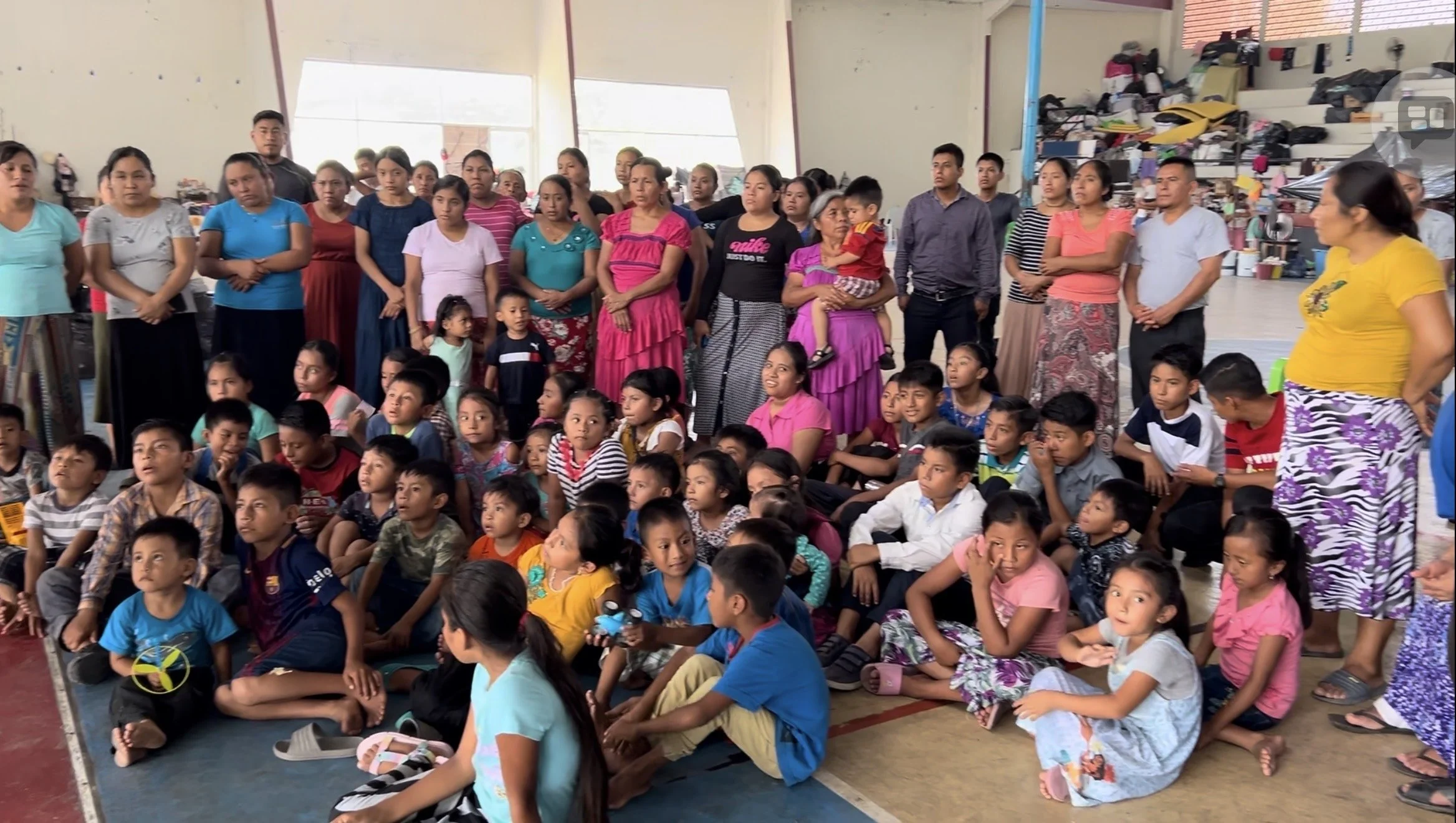 Children and adults listening to a Bible teaching