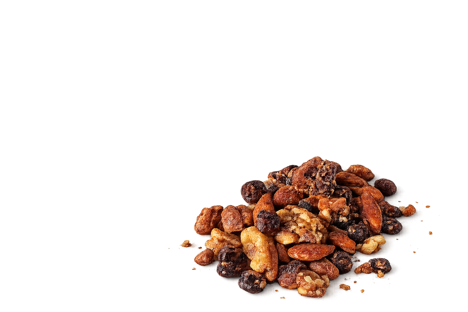 A pile of mixed nuts including almonds, cashews, and hazelnuts on a flat surface.