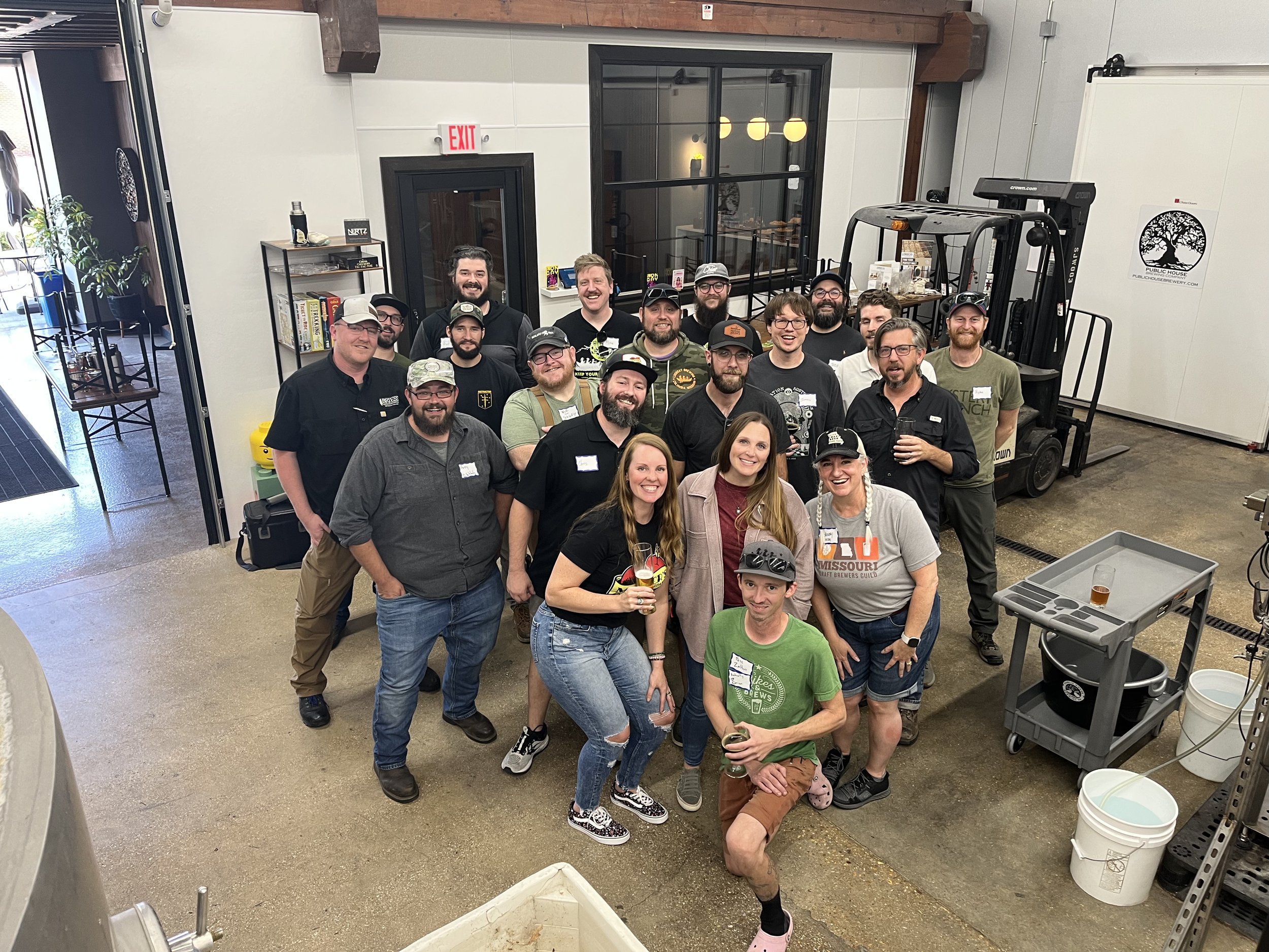 group of women and men posed together at public house brewing company after brewing the missouri loves company baltic porter