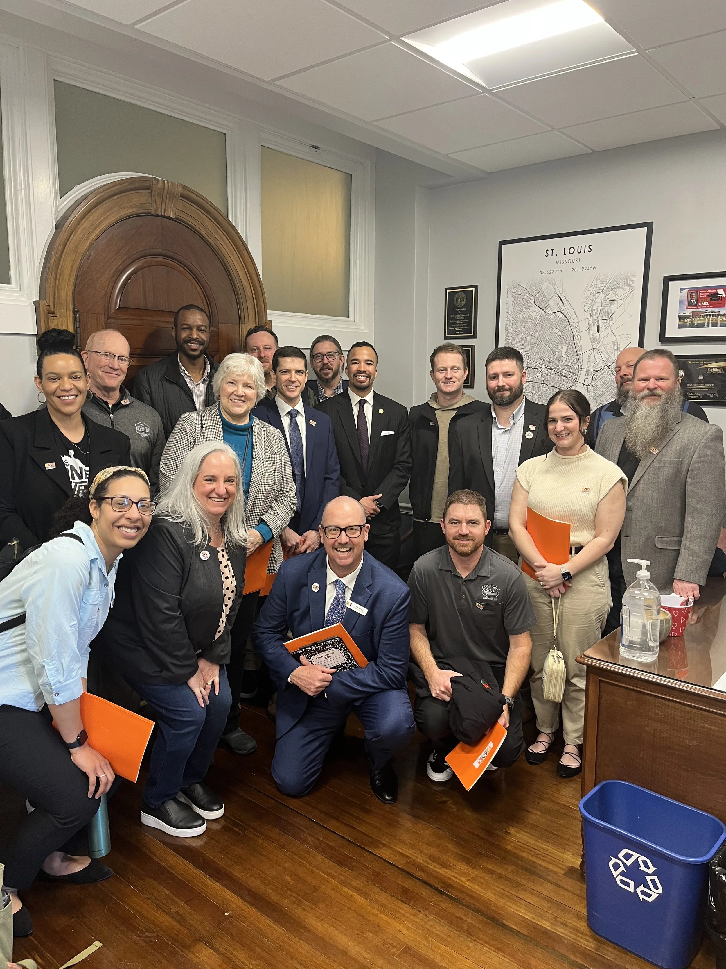 group of women and men posed together in the office of a missouri state senator