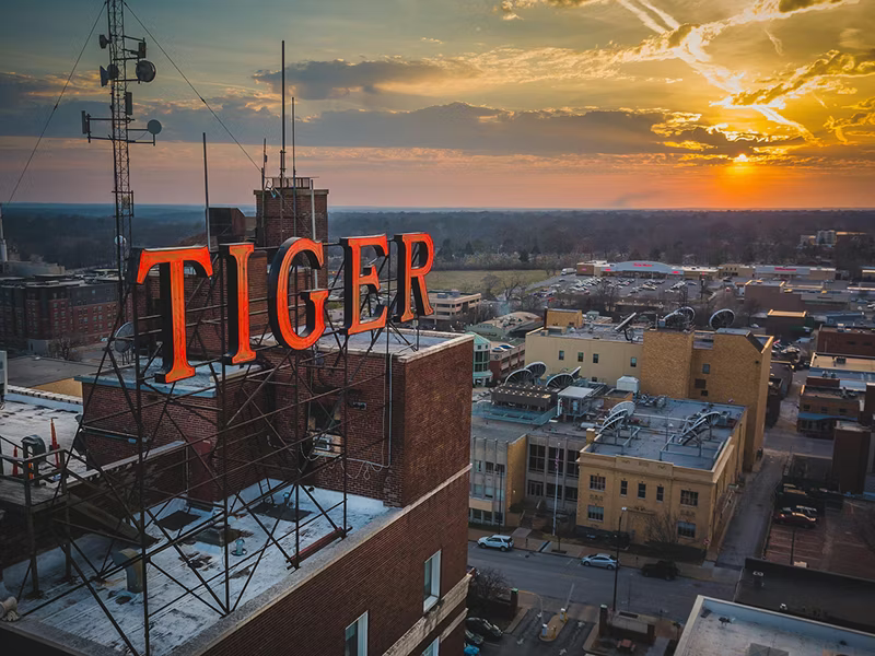 The Tiger Hotel exterior rooftop sign and sunset
