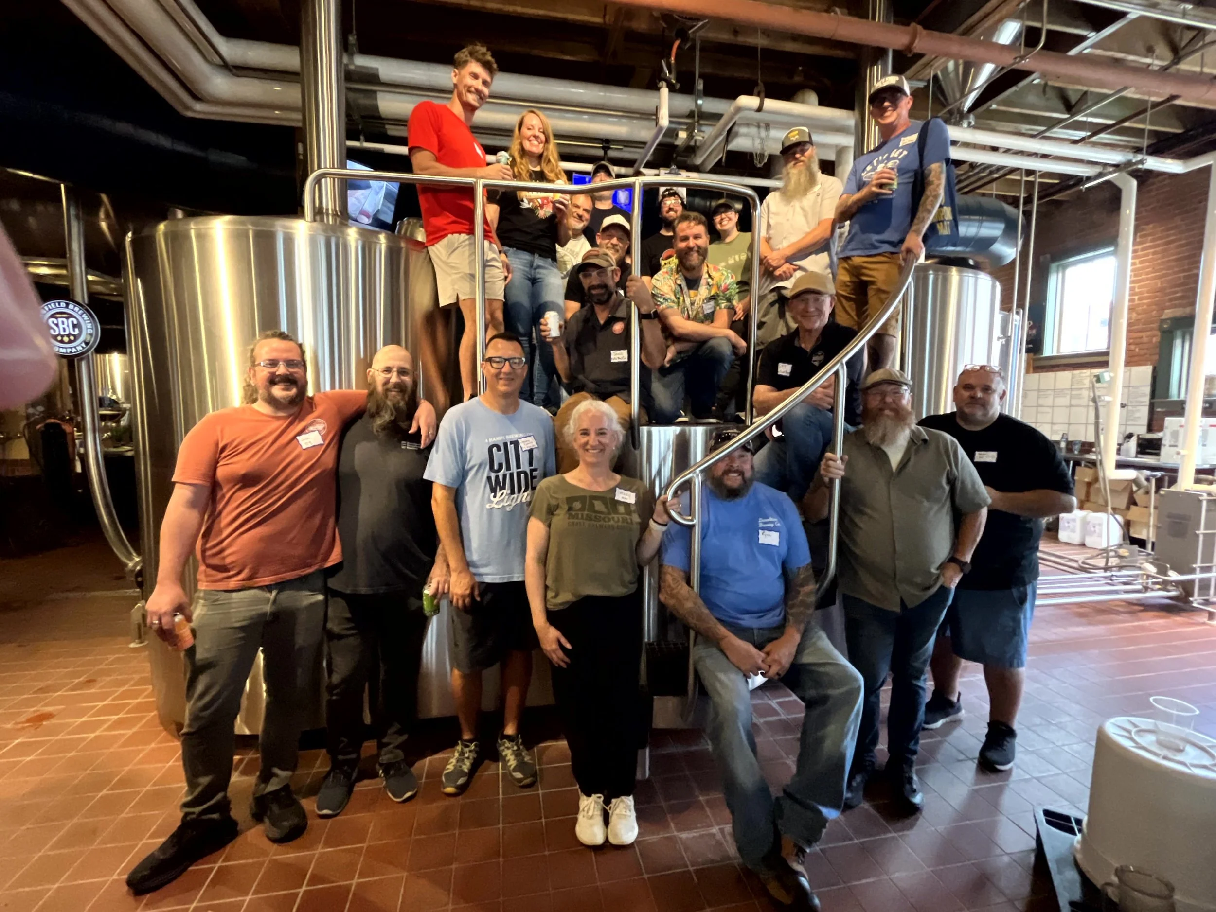 a group poses on the brew deck at springfield brewing company