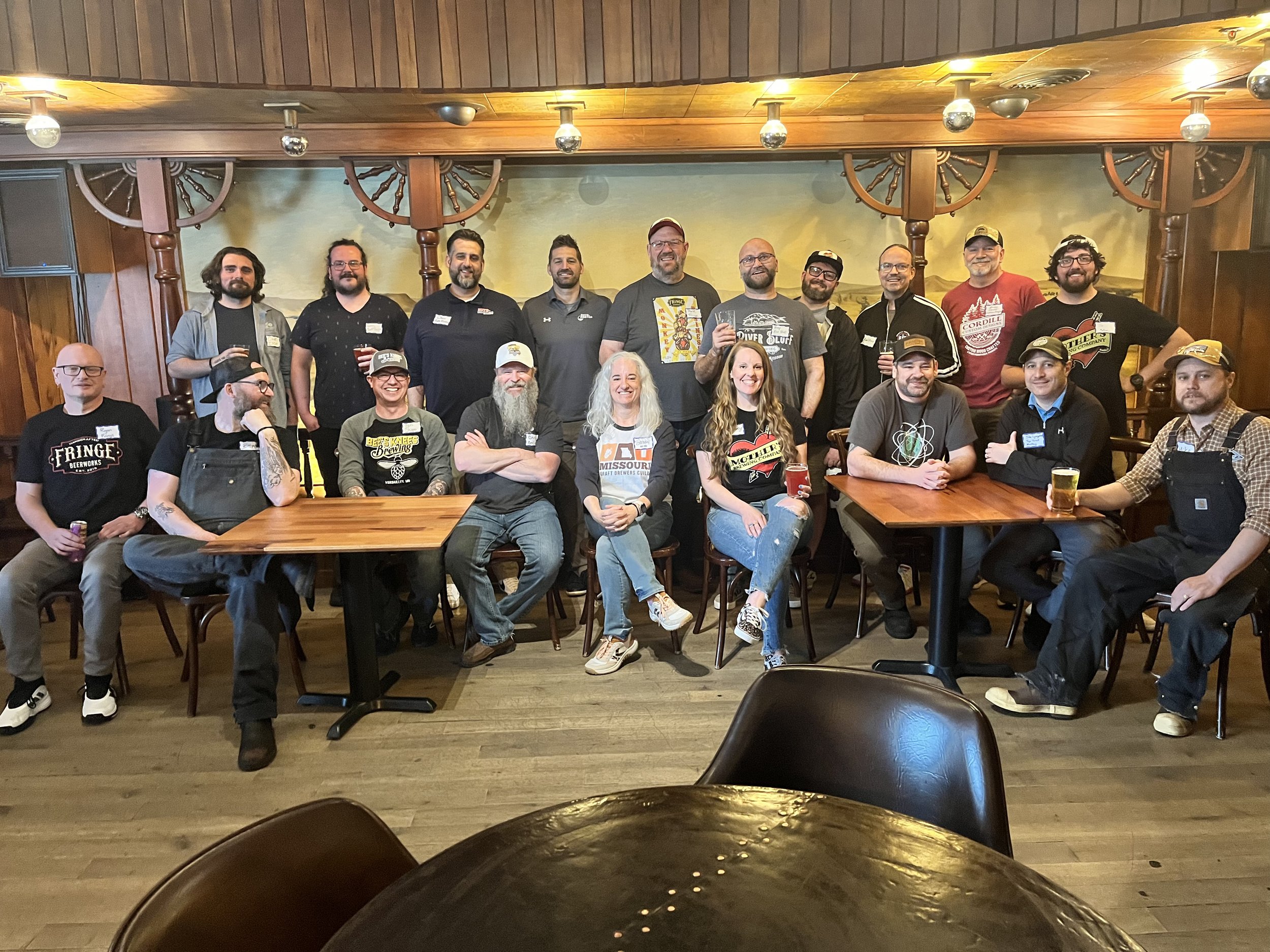 group of smiling people in the iconic taproom at stockyards brewing in the former golden ox restaurant