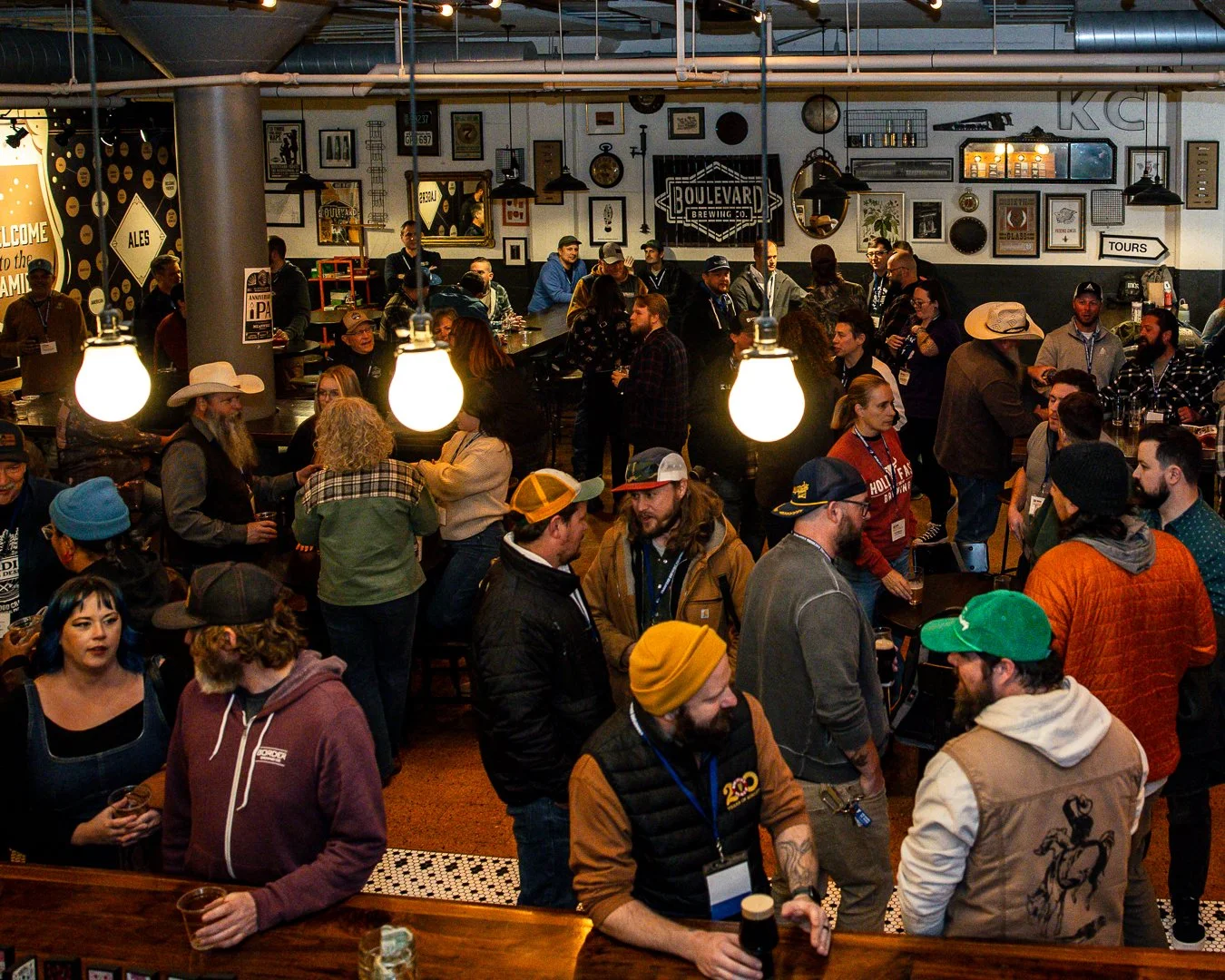 the tasting room at boulevard brewing is packed full of people networking and enjoying beers in this overhead shot