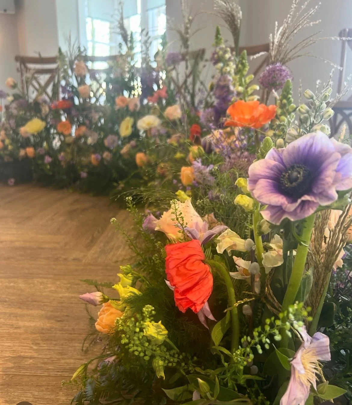 Wedding ceremony Fresh Flower meadow designed by Carol Peacock of Peacock & Wild (formerly The Blossom Room luxury wedding floral design, image has anemones and spring flowers as a sustainable design