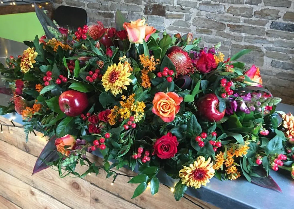 Autumn time red and orange Flowers and fruit casket spray, wigan florist Formerly The Blossom Room