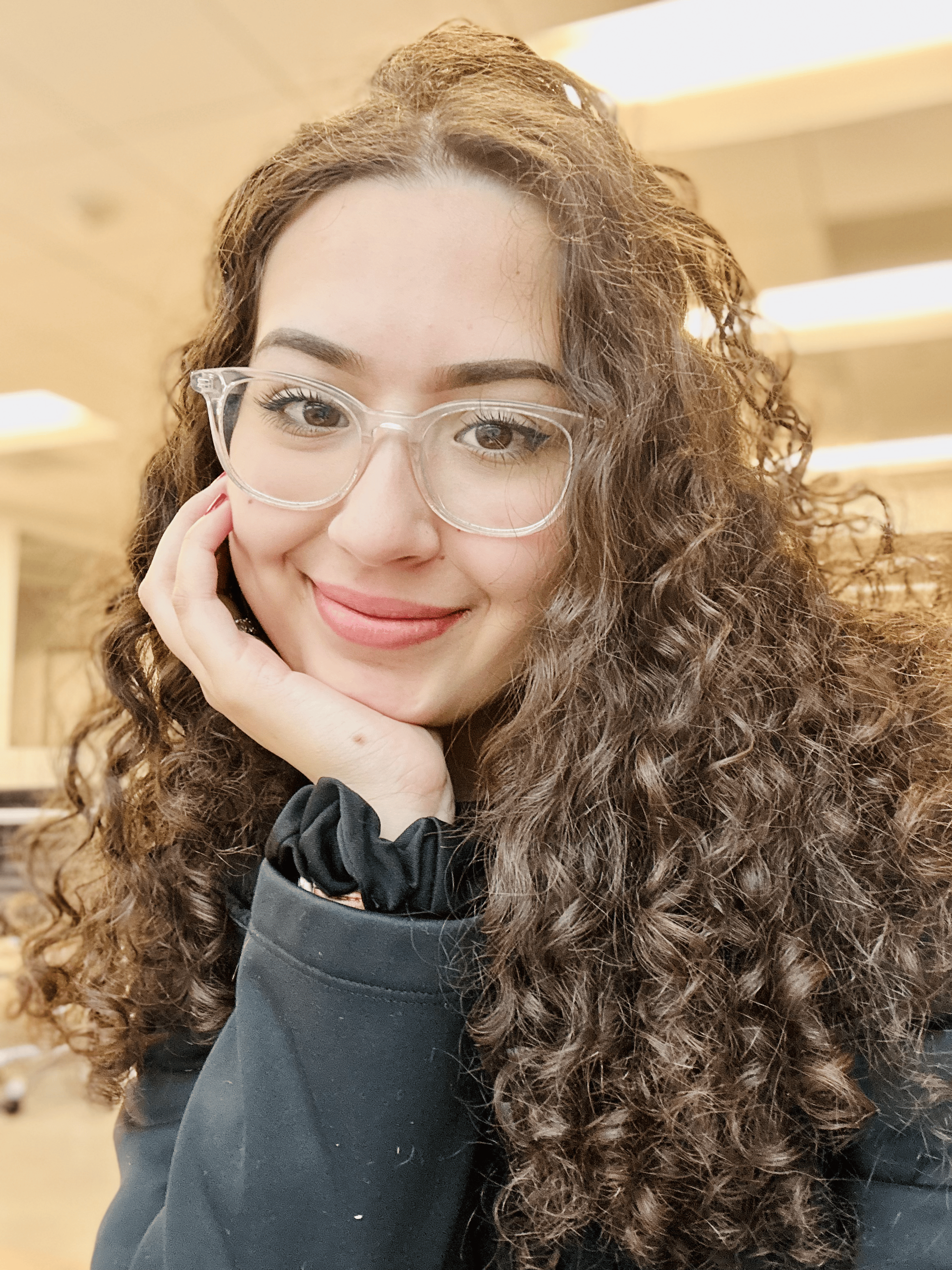 Missing Manual founder Sabrina Santos smiling at the camera in an indoor setting.