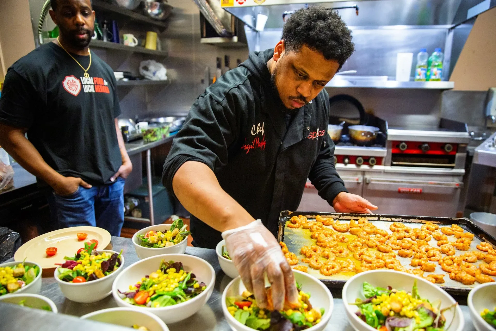 Chef Brazil Murphy plates shrimp salads as part of the Local Food for Local Heroes dinner. Photograph by Erica Baker