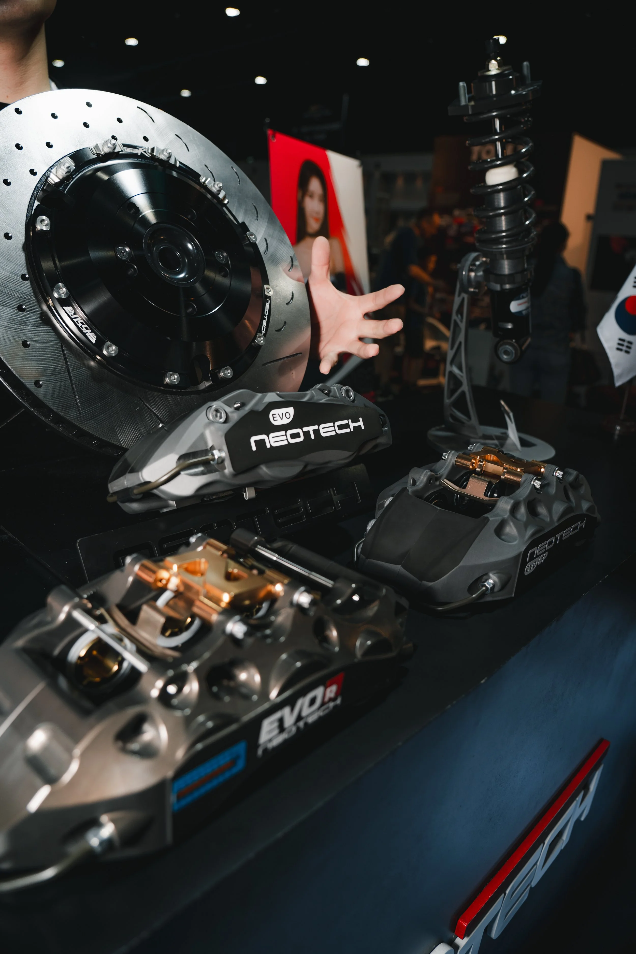 Display of Neotech Evo brake calipers and carbon fiber disc brake rotors for high-performance vehicles.