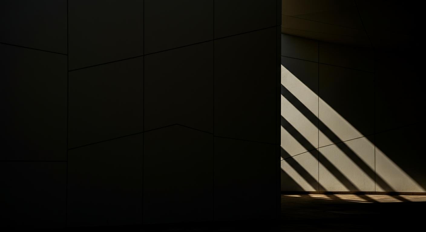 Dark interior with sunlight casting diagonal shadows through a railing, illuminating part of a wall.