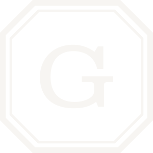 Black stop sign with white letter 'G' in the center