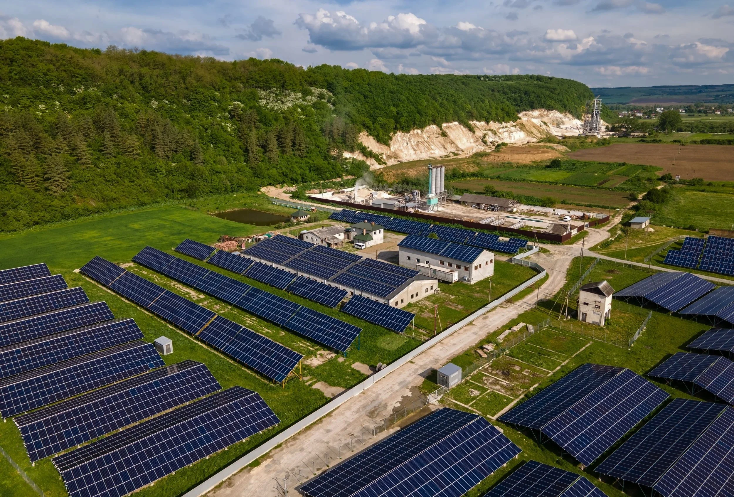 Interior view of an art gallery with curved, ribbed architectural design, white walls, and framed artworks on display.