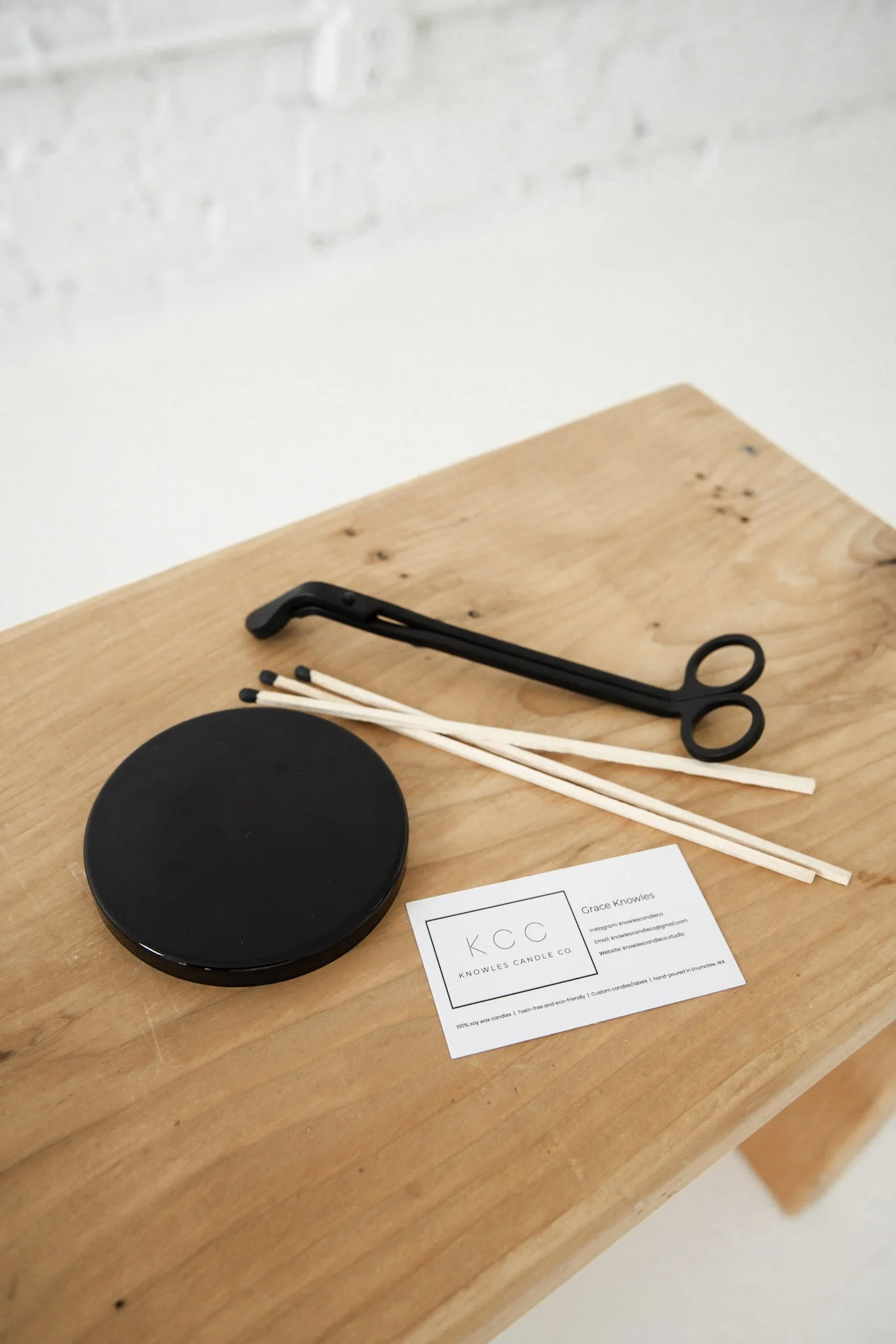 12 oz black candle lid with a smooth, metallic finish