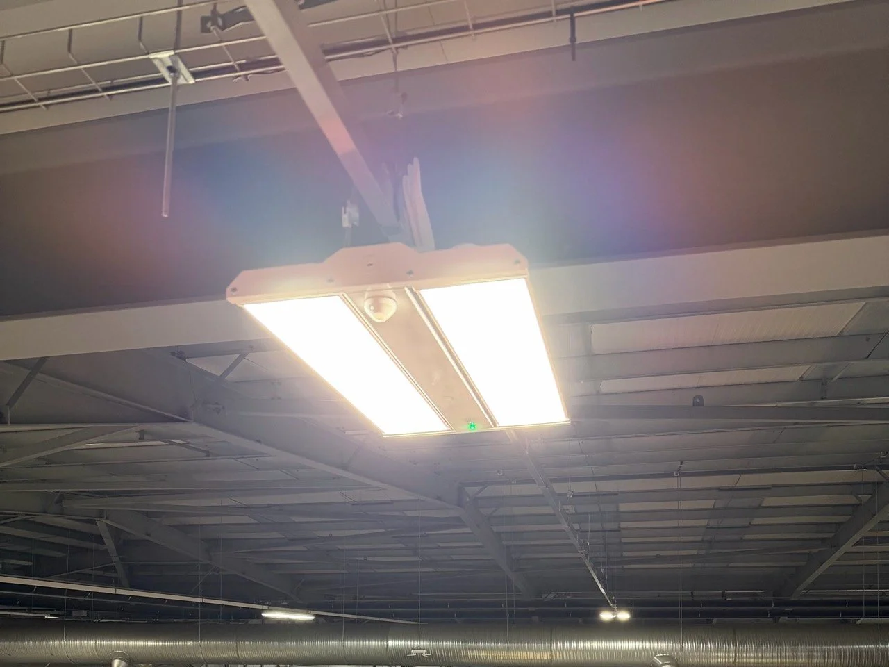 Illuminated high-bay light fitting beneath the warehouse roof at LX Pantos, Lutterworth.