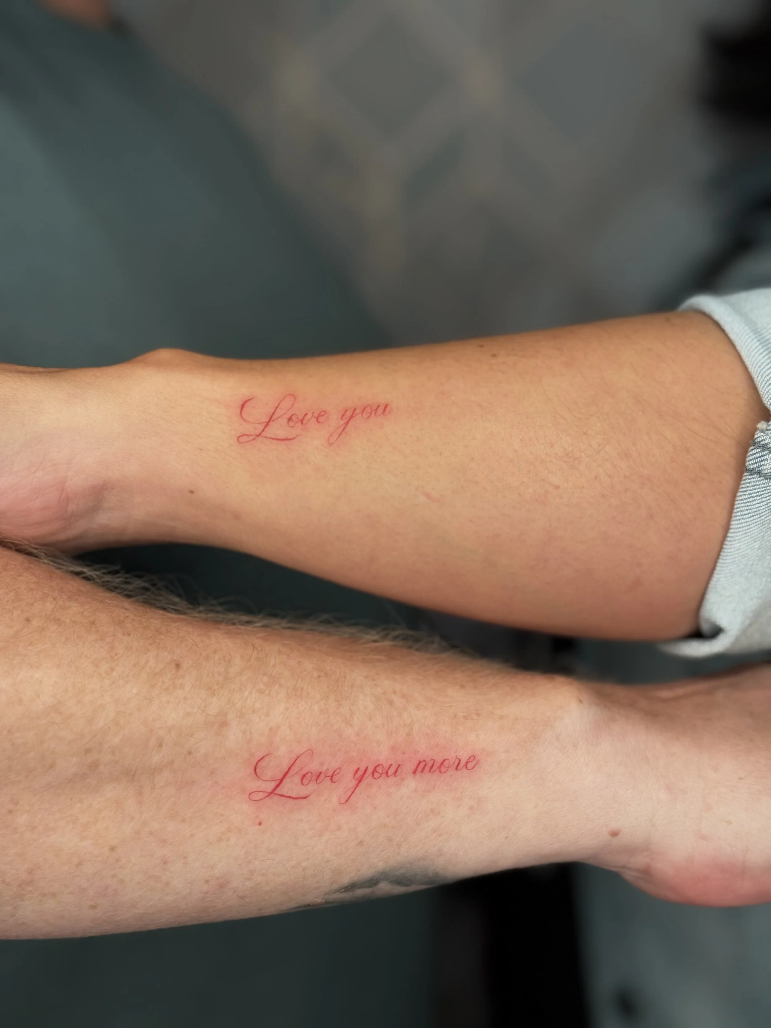 Fine line matching script tattoos on forearms by a Dearborn fine line tattoo artist