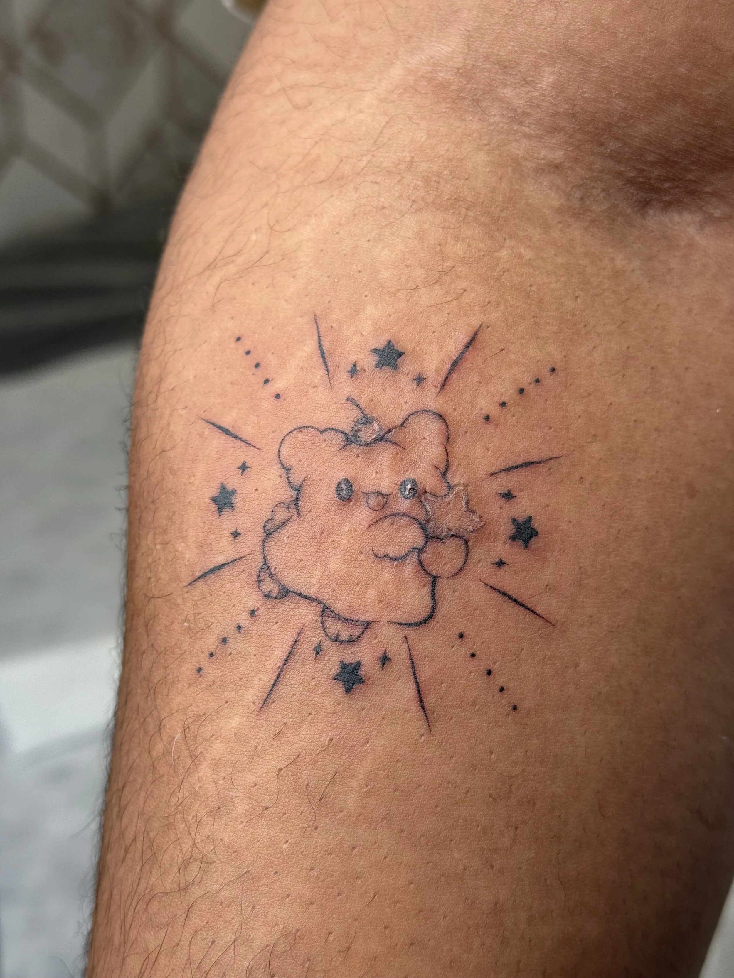 Fine line cloud character tattoo inspired by Sanrio with stars and dotwork on arm