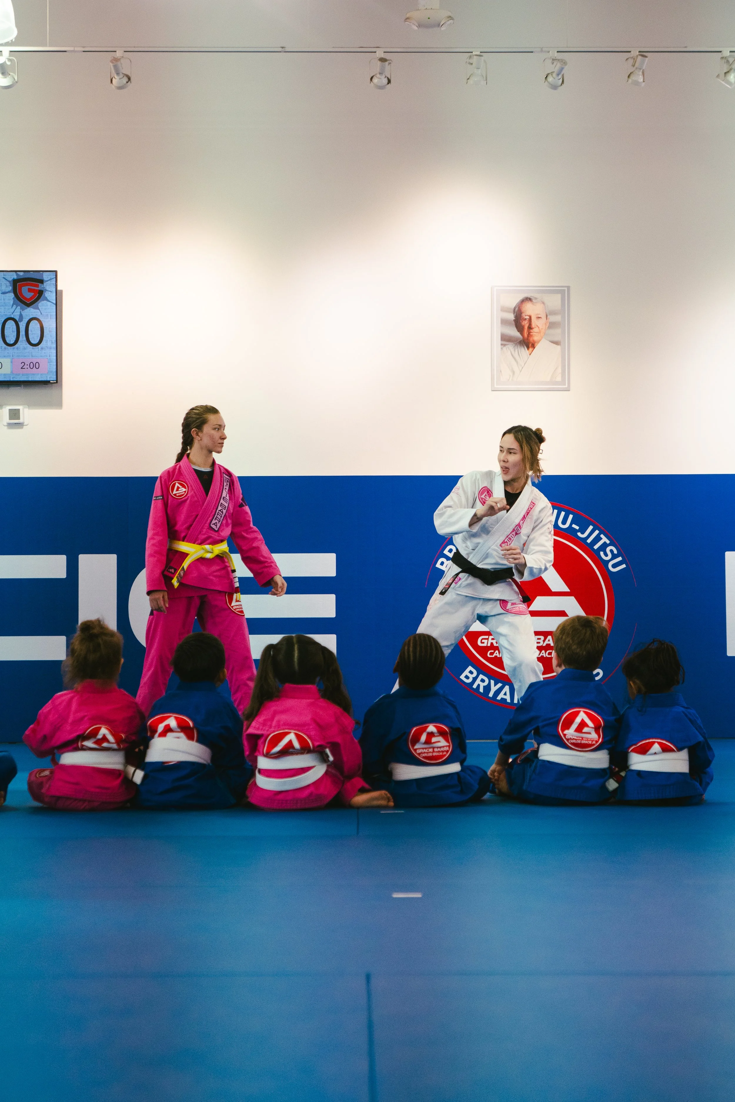 Two instructors teaching a class of little champs at Gracie Barra Bryan.
