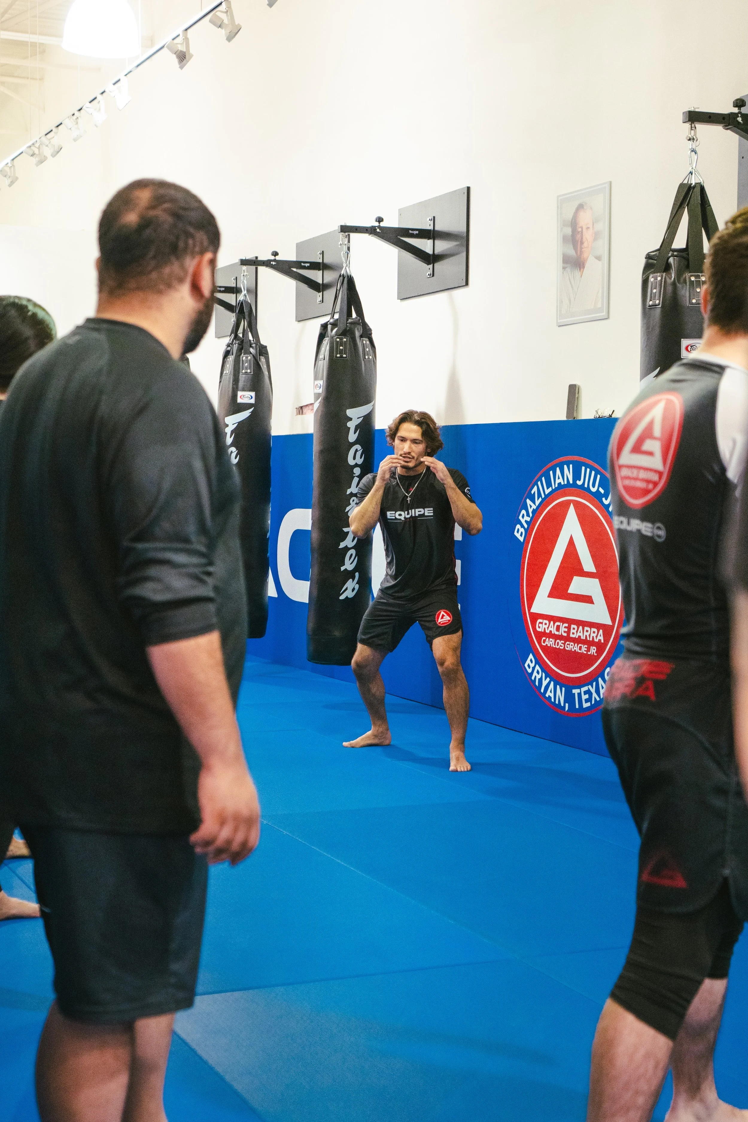 Instructor teaching kickboxing to a class of students at Gracie Barra Bryan.