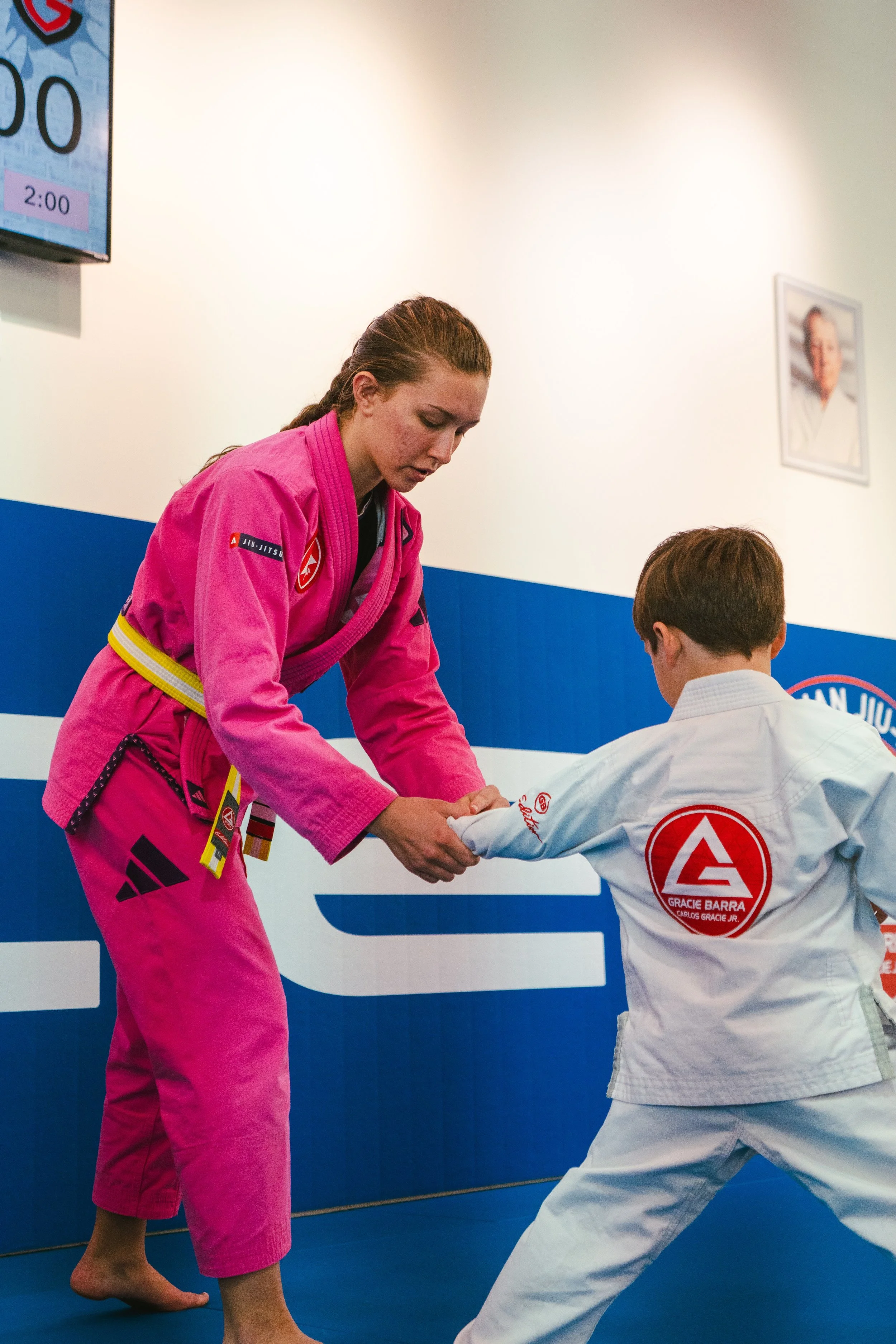 Instructor giving private lessons to a young kid at Gracie Barra Bryan.