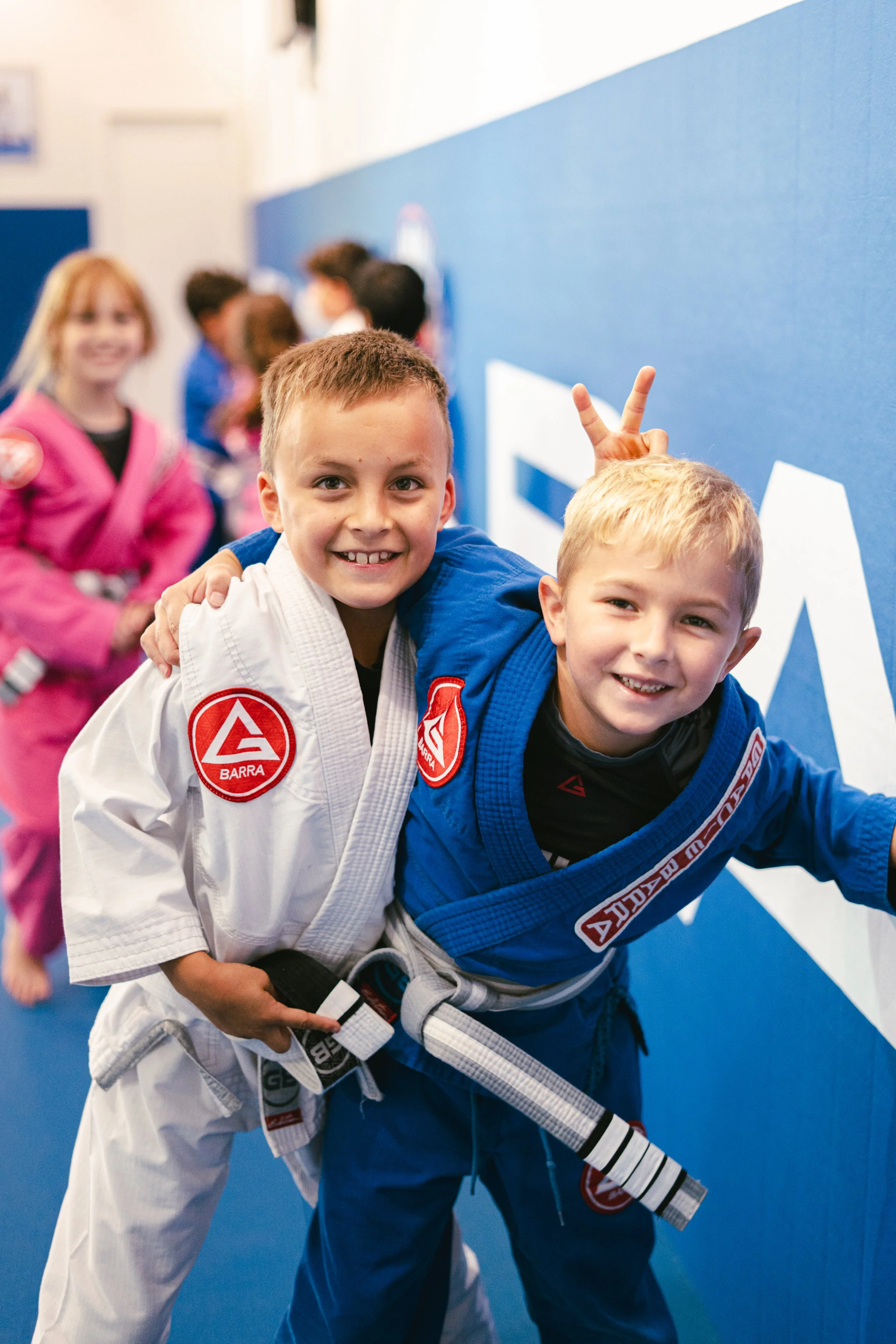 Two little boys smiling in Kids Class at Gracie Barra Bryan.