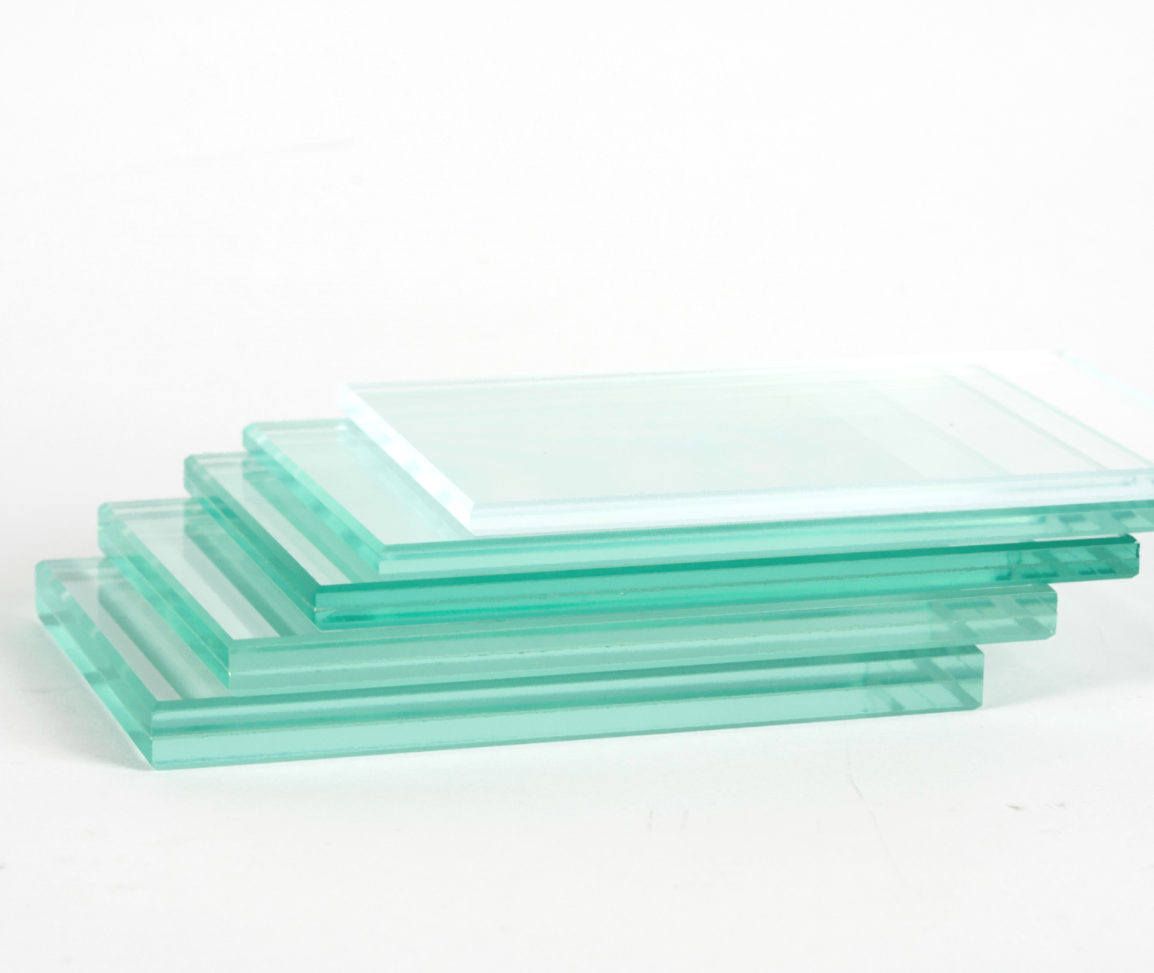 Stack of transparent glass rectangles in varying sizes, tinted with a light green color, arranged in a pyramid shape, against a white background.