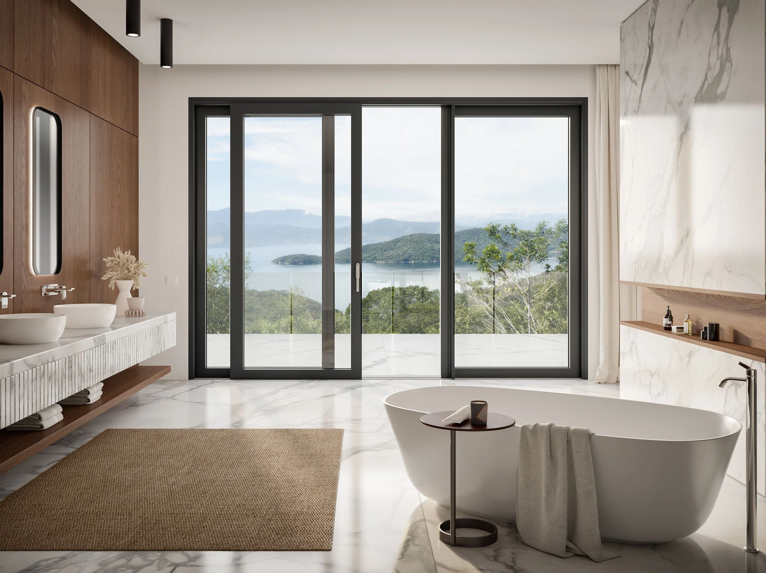 Modern bathroom with a view of mountains and a lake through large glass sliding doors, featuring a freestanding bathtub, marble flooring and walls, and natural wood accents.