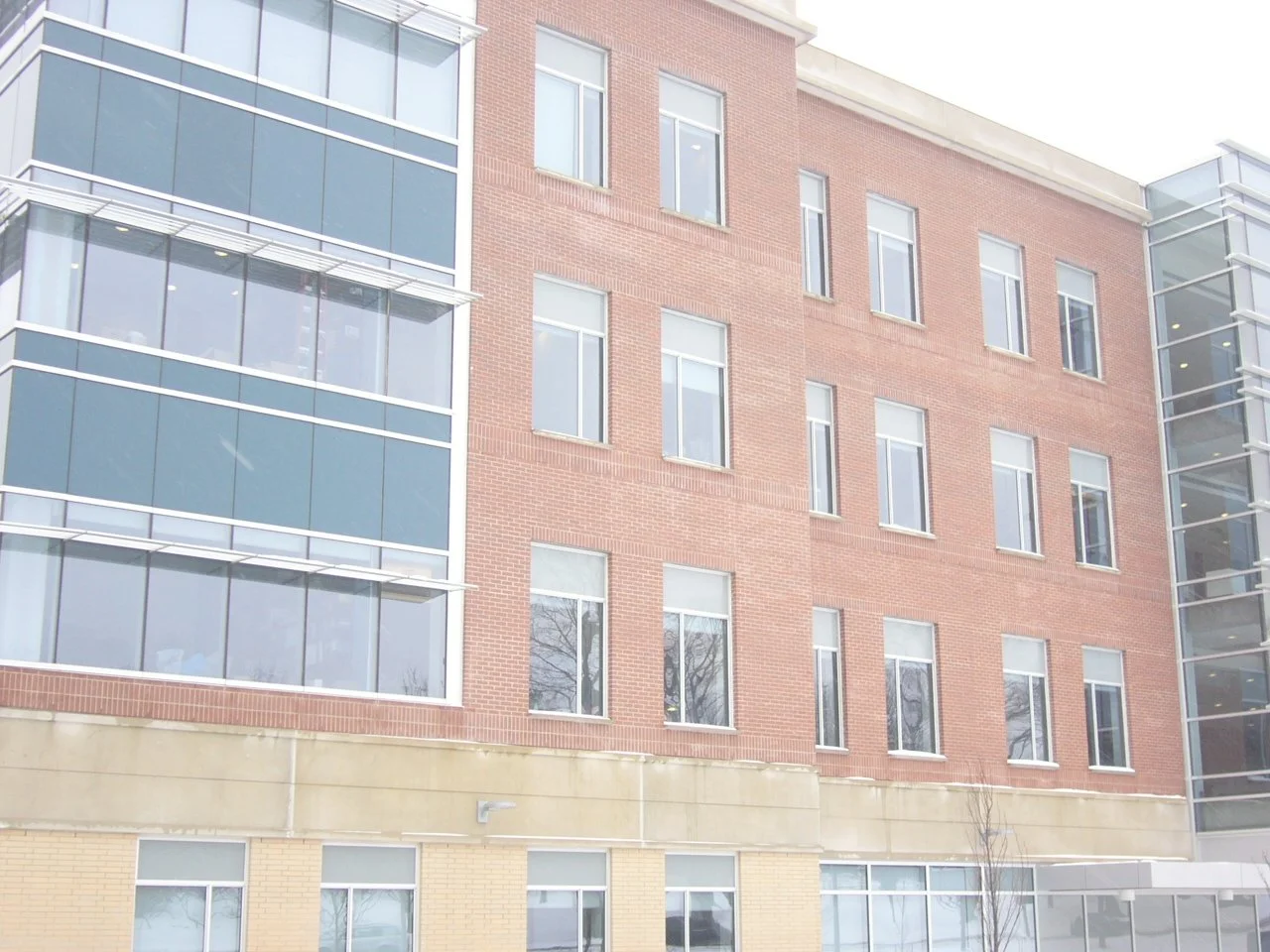 Modern multi-story building with brick and glass facade.
