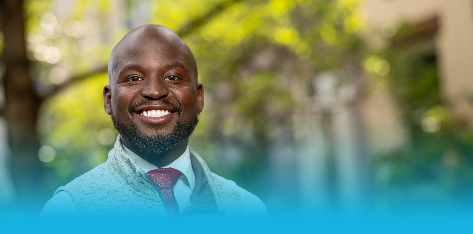 Oye Owolowa, candidate for DC Council At-Large, smiling outdoors.