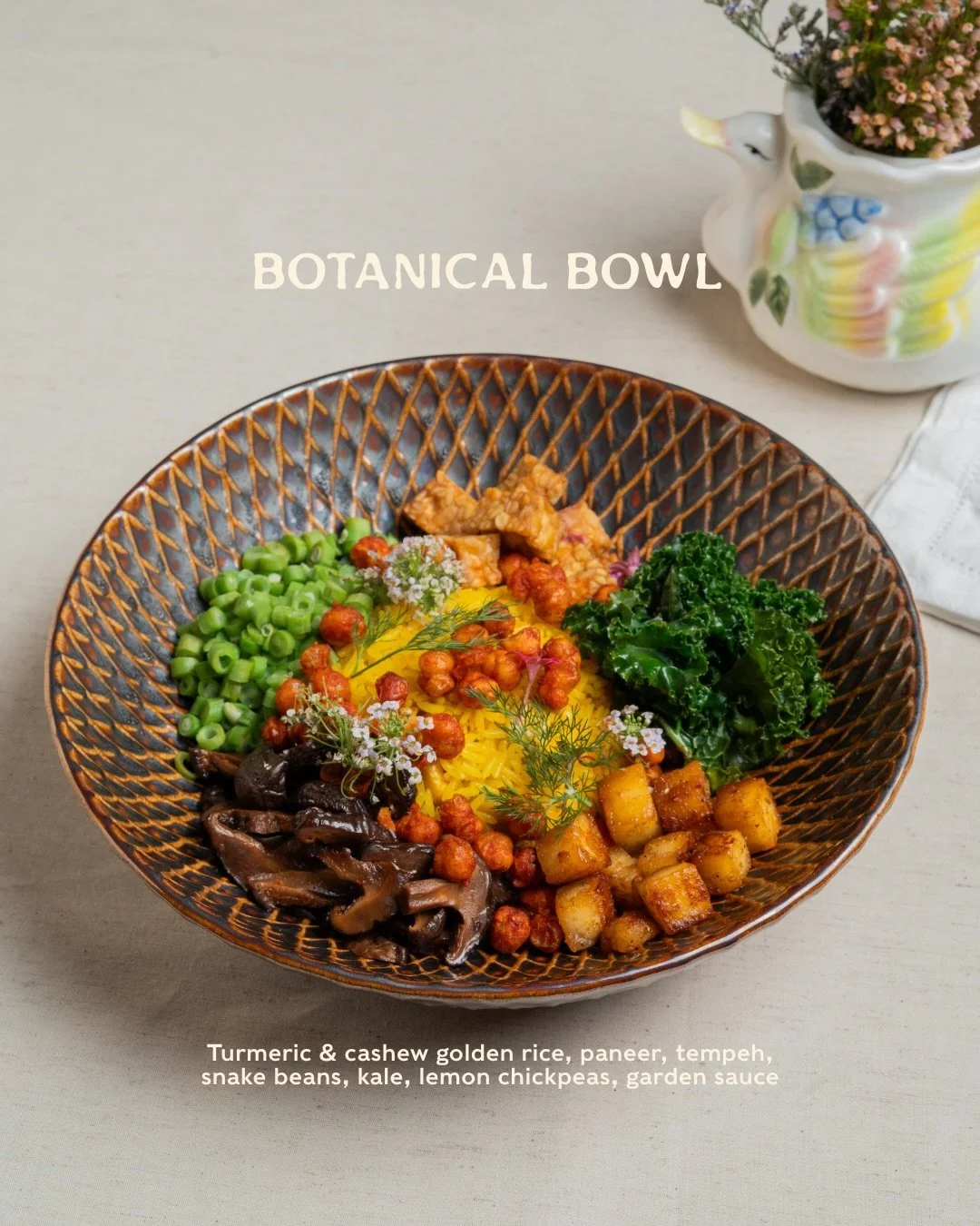 A bowl built on the joy of mixing things through. 🌱

Golden turmeric rice layered with paneer, tempeh, snake beans and crispy chickpeas &mdash; textures in every forkful. To be finished with our herb sauce, poured generously over the top to bring th