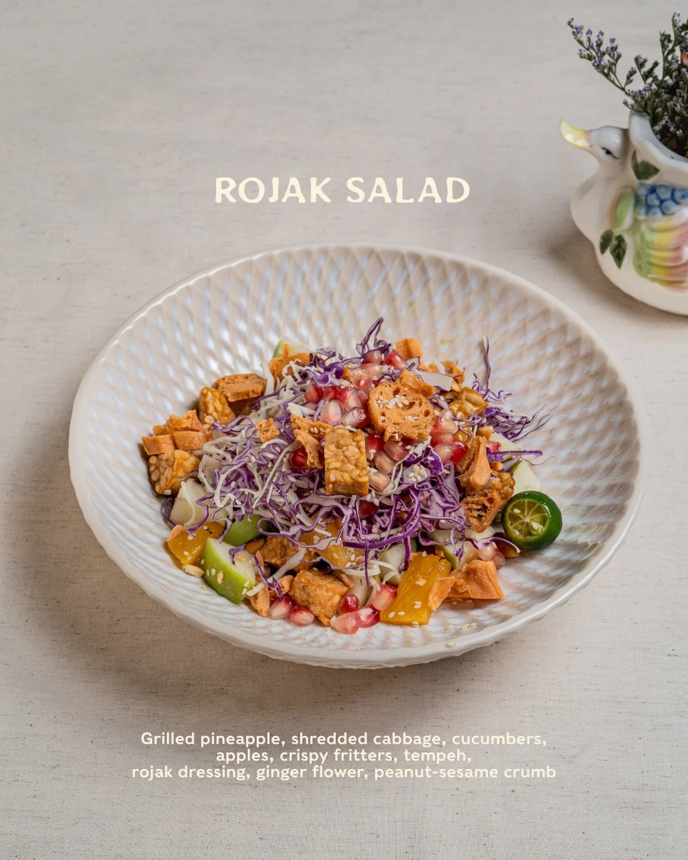 Sweet pineapple, crisp greens, cool cucumber, and apples for that crunch.

Tossed in a bright, lightly nutty dressing with ginger flower, with golden fritters and tempeh on top.

Inspired by rojak, but not quite, think of it as a fresh, juicy slaw wi