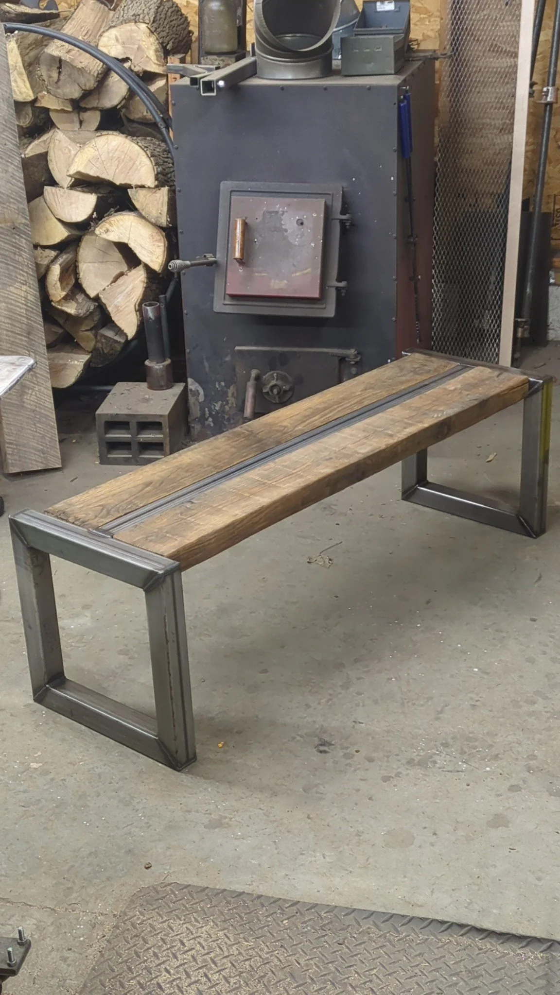 Custom entryway bench with 100 year old barn wood and a raw steel finish